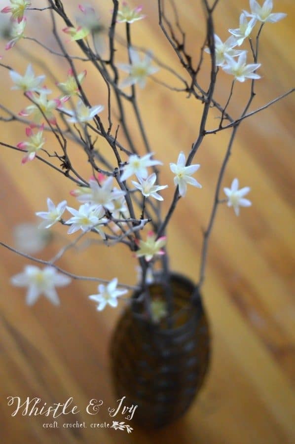 Use some stick, twigs and artificial flowers to create the gorgeous twig blossom bouquet centerpiece.