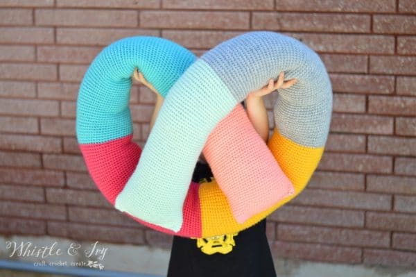 Free Crochet Pattern: Crochet Pretzel Pillow | This fun, pretzel-shaped pillow is fun to make, and fun to use and is multifunctional!