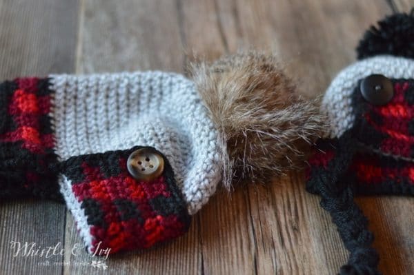 FREE Crochet Pattern: Crochet Baby Plaid Trapper Hat | Make this adorable rustic plaid hat for baby this winter! Includes three sizes. 