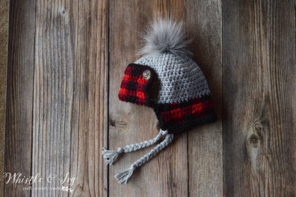FREE Crochet Pattern: Toddler Plaid Trapper Hat | Keep your toddler toasty warm in this trendy buffalo plaid detail hat! Two strands make it extra cozy.