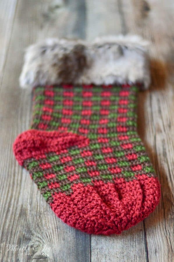 FREE Crochet Pattern: Crochet Plaid Stocking | Bring a rustic and classic look to your holiday decor with these fur-topped Christmas Stockings. 