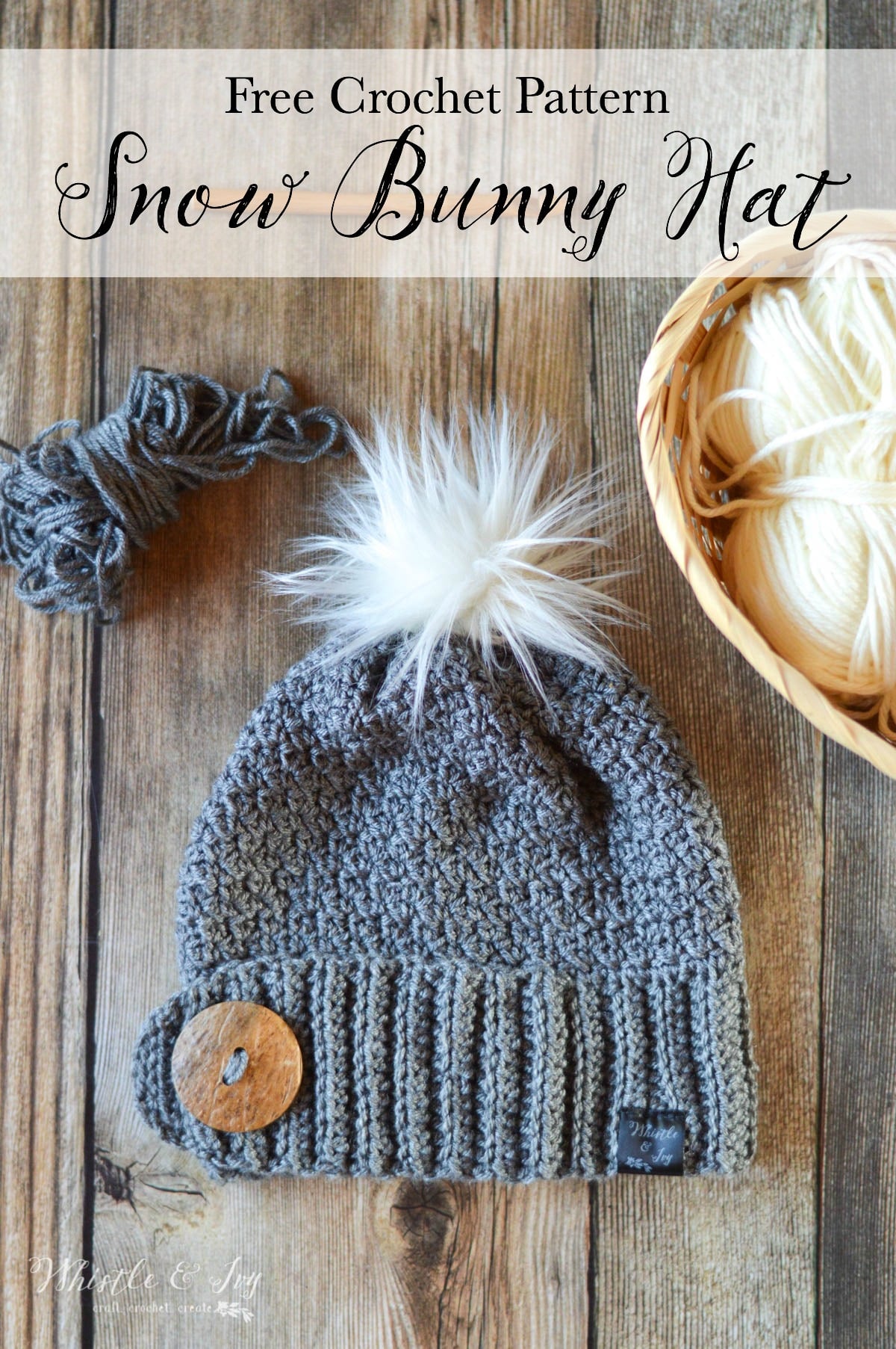 Crochet hat with large button and white fur pom-pom on top