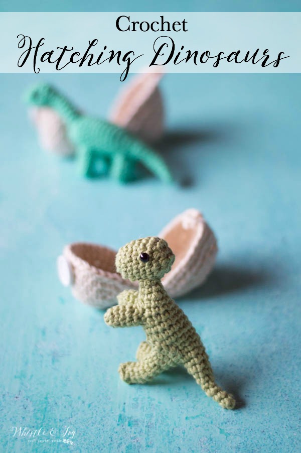 crochet hatching dinosaur baby t-rex standing in front of an egg