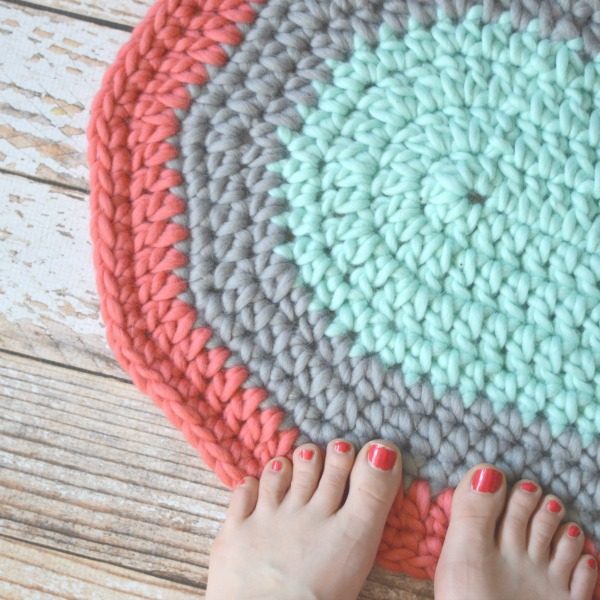 soft crochet rug with feet standing on it