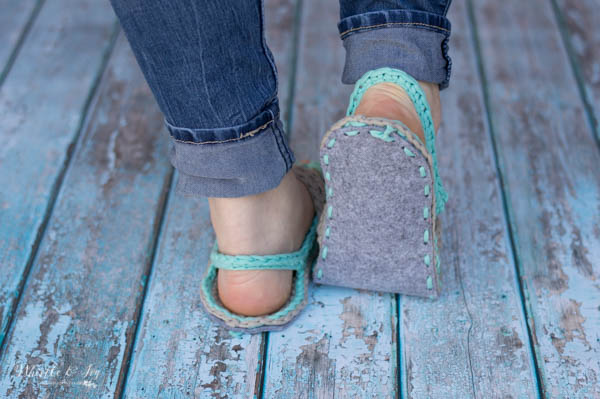 heel showing woman wearing crochet flip-flops