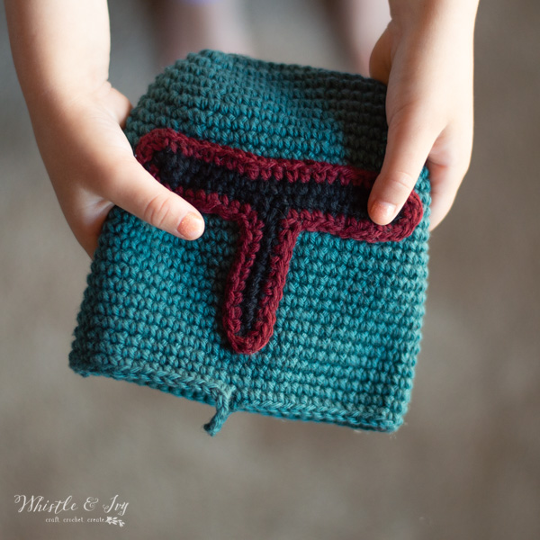 child holding boba fett crochet pouch 